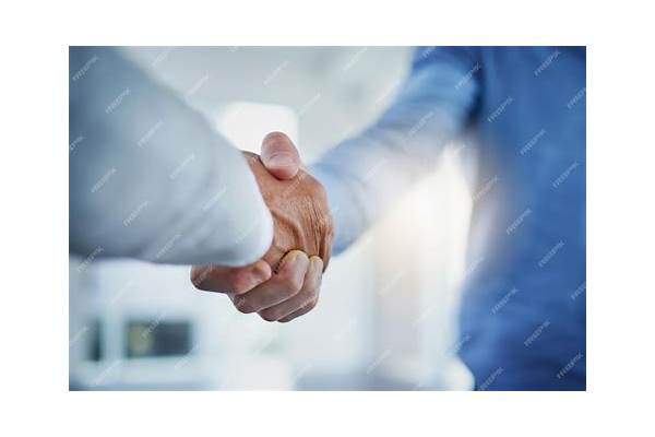 Business professionals shaking hands, implying insurance agreement