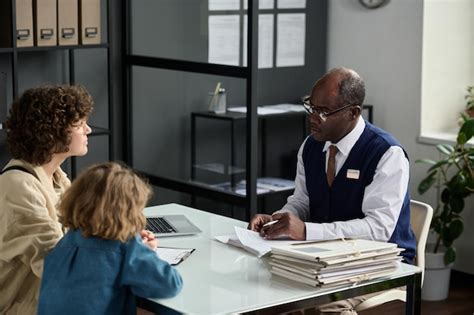 An insurance agent in a local office setting, consulting with a family about their policy options