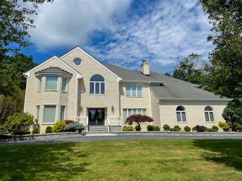 A charming suburban house in New Jersey with a well-maintained lawn.