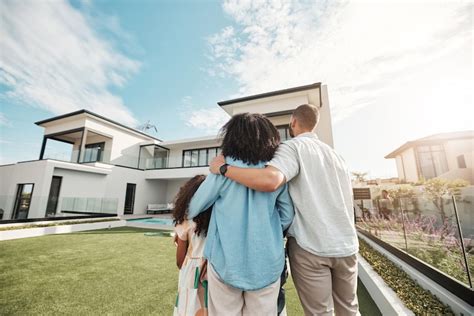 A family standing in front of a new house, looking happy and secure, symbolizing home insurance protection.