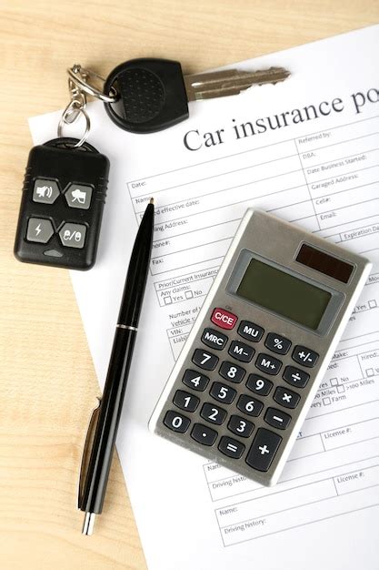 A set of car keys and house keys resting on an insurance document, symbolizing home and auto protection.